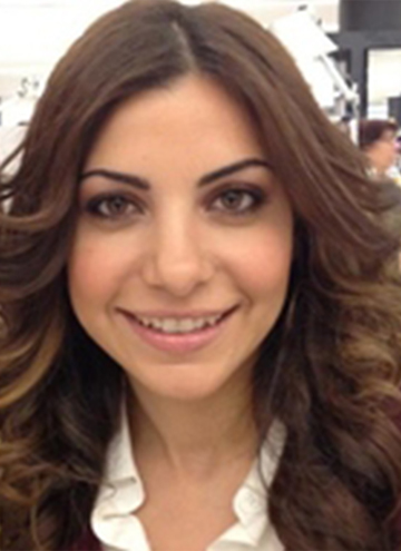 Photo of Tamar Boyadjian. Portrait of smiling young woman with shoulder length brown curly hair.