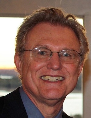 smiling man with glasses in a suit