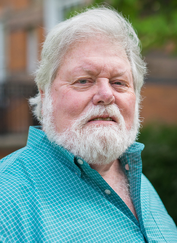 Photo of Patrick O’Donnell. Older man with white hair and beard. Wearing teal checkered button up.