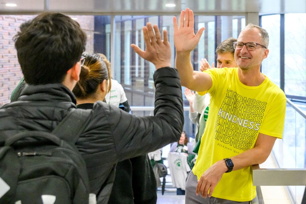 Josh Kilmer Purcell high-fives a Michigan State student during their 2023 Earth Day community service projects.